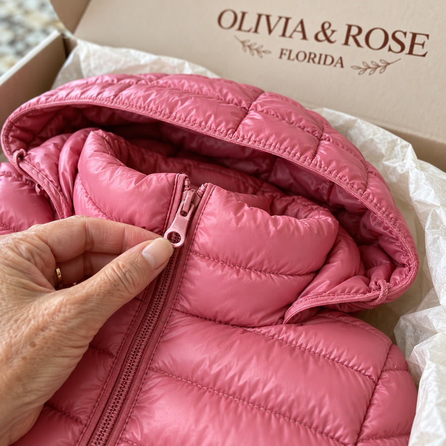 Close-up of the narrow quilting and zipper of the Feathra in its Olivia & Rose box