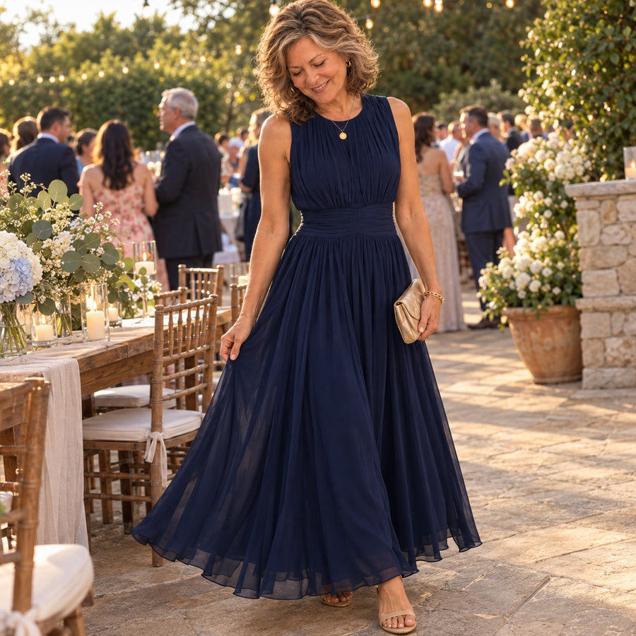 A woman wearing the navy Iselle at an outdoor wedding
