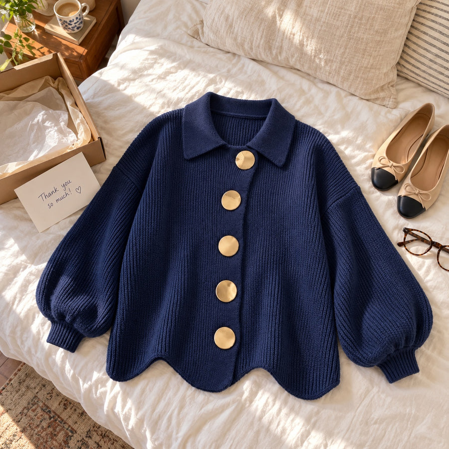 The navy Karina laid out on a bed, showing the full sleeves