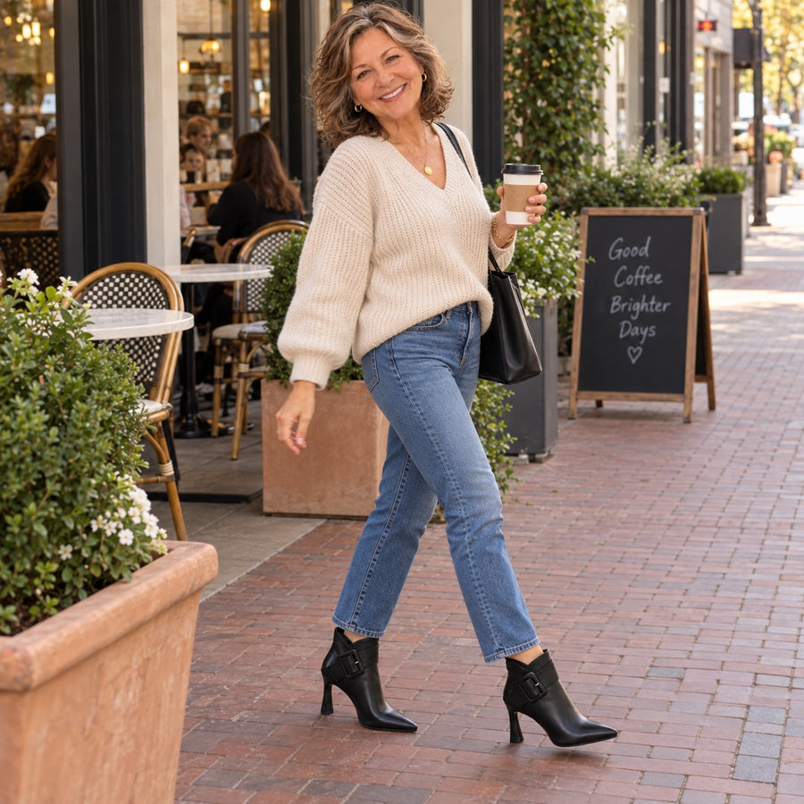 A woman walking through town in the black Raina boots