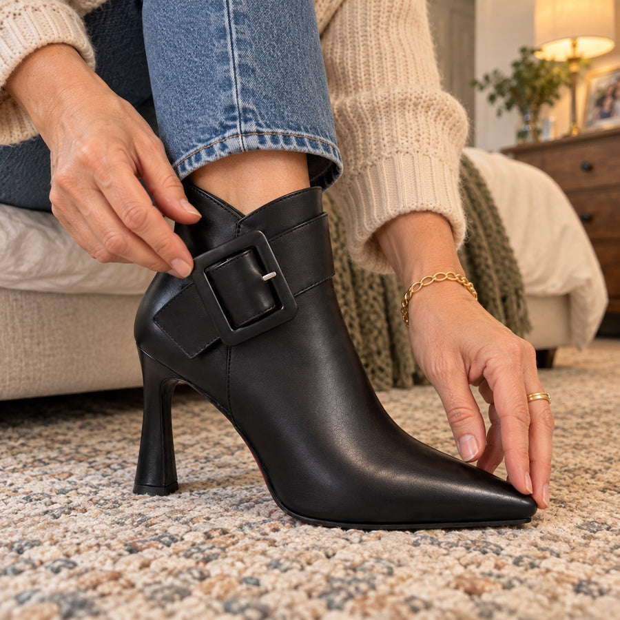 Close-up of the oversized buckle and pointed toe of the Raina